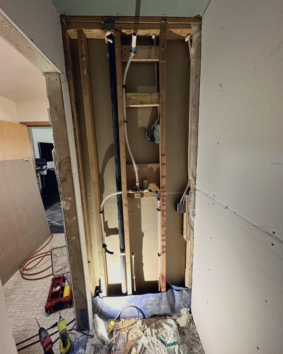 Repipe in progress: new PEX and copper stubs in an open wall