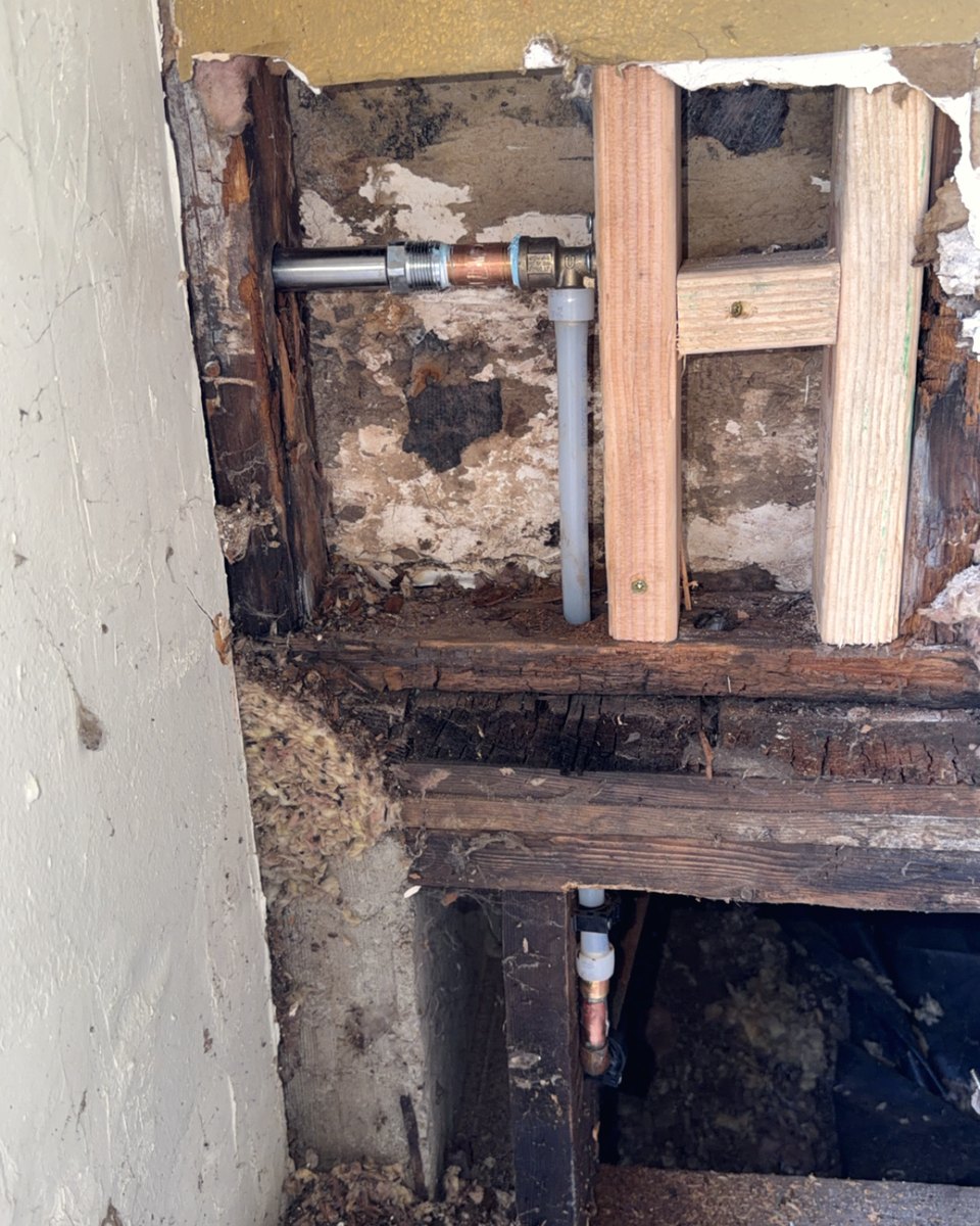 What we found behind a wall: rotted framing around old pipe